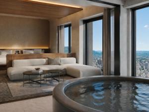 a living room with a jacuzzi tub in a hotel room at FAV LUX Asahikawa in Asahikawa