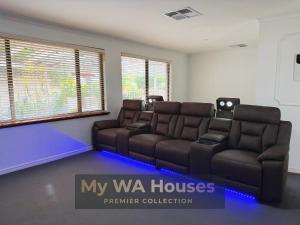 a living room with a couch and a couch and chairs at Edgewater Whole Holiday Resort in Perth