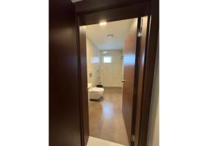 a bathroom with a toilet and a glass door at Kanak Residency Kuthuparamba in Kottayam +63 photos