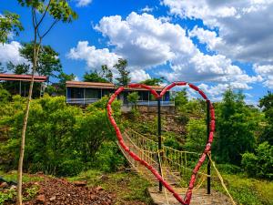 a red heart tied to a rope swing at Royal Villa Resort in Sāngli