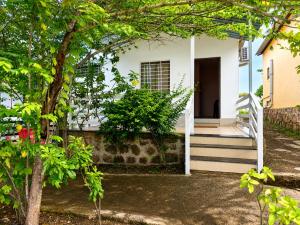 a white house with stairs leading to a door at Royal Villa Resort in Sāngli