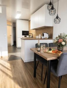 a kitchen with a table with a plate of food on it at See- & Bergblick Oberteuringen 59 mit beheiztem Indoor-Pool in Oberteuringen