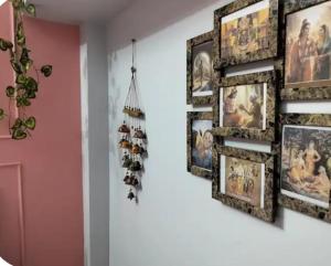 a group of pictures on a wall in a room at Whispring hills hotel in Sodākor +1 photo