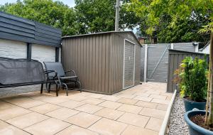 a patio with a bench and a fence at B&G Homes in Hollinwood