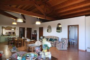 a living room with a table and chairs at Antico Frantoio Rooms in Sambuca di Sicilia