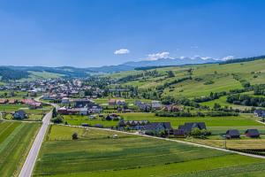 an aerial view of a small village in the hills at DW KINGA Domki całoroczne 6 os z widokiem na Tatry in Kacwin