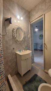 a bathroom with a sink and a mirror and a shower at Lo de Julia in Formosa