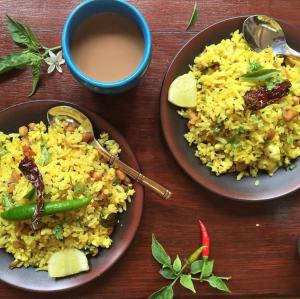 a table with two plates of rice and a cup of coffee at Hotel The De - Pacific Suites Near Delhi IGI Airport in New Delhi +16 photos