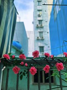 a bunch of pink roses on a fence at Ngõ Saigon Homestay in Ho Chi Minh City