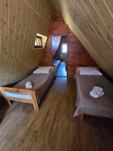 a room with two beds in a attic at Górski Ośrodek Pod Kamiennikiem in Poręba