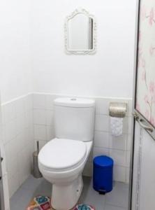 a bathroom with a white toilet in a room at SunBeachHouse in Weligama