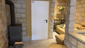 a white door in a room with a brick wall at Ferienwohnung Für 4 Personen 90 M² in Naumburg