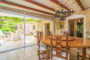 a dining room with a wooden table and chairs at Casa Margarita in Andratx
