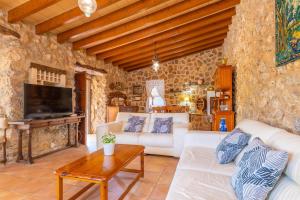 a living room with a white couch and a table at Casa Margarita in Andratx