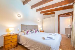 a bedroom with a large white bed in a room at Casa Margarita in Andratx +35 photos