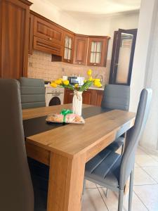 a kitchen with a wooden table with a vase of flowers on it at L Isola in Càbras +6 photos