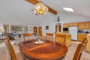 a kitchen and dining room with a wooden table and chairs at Mt. St. Helens - Unit 9 in Sunriver