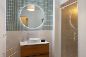 a bathroom with a sink and a mirror at T2 Design Centre Cité 10 min in Carcassonne +7 photos