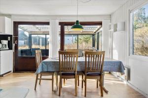 a dining room with a table and chairs and a window at 828-Thisted-Orredvej-13 in Thisted +10 photos