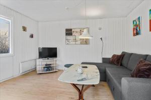 a living room with a couch and a tv at 828-Thisted-Orredvej-13 in Thisted