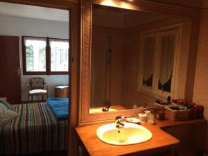 a bathroom with a sink and a mirror and a bed at Chalet de l'Esquirol in Bolquere Pyrenees 2000 +55 photos