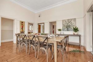 a dining room with a large wooden table and chairs at Central Charm in Echuca