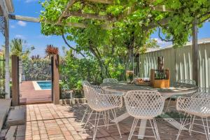 a patio with a table and chairs and a pool at Central Charm in Echuca