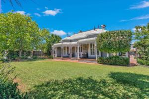 a large white house with a large yard at Central Charm in Echuca