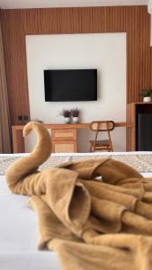 a living room with a towel on a bed at Enso Villa and Hotel in Munggu