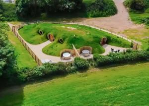 an aerial view of a park with a fence at Arts Hollow in Binegar