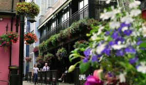 a group of people walking down a street with flowers at Hotel Rue in Omagh