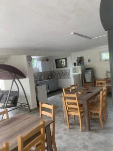 a kitchen and dining room with a table and chairs at LouNik stay hotel and rooms in Kobuleti