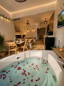 a bath tub filled with red flowers in a room at panorama pyramids and jacuzzi in Giza