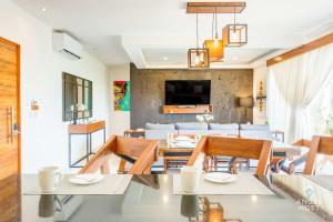 a dining room and living room with a table and chairs at Eight Condos Multi Listing in Playa del Carmen +27 photos