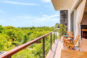 a balcony with a view of the forest at Eight Condos Multi Listing in Playa del Carmen