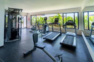 a gym with several treadmills and exercise bikes at Syrena Multi Listing in Playa del Carmen