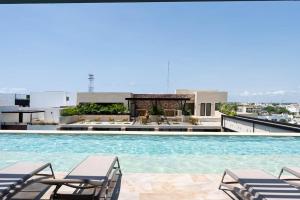 a swimming pool on the roof of a building at Syrena Multi Listing in Playa del Carmen
