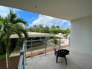 a black chair sitting on the balcony of a house at Magia Multi Listings in Playa del Carmen