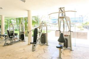 a gym with treadmills and weights in a building at Magia Multi Listings in Playa del Carmen