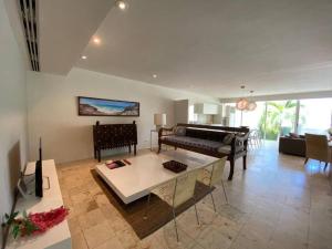 a living room with a couch and a table at Magia Multi Listings in Playa del Carmen +17 photos