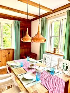 a dining room with a table with a red and white checkered table cloth at House at Jenischpark in Hamburg