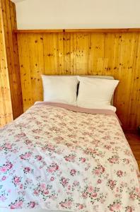 a bedroom with a bed with a floral bedspread at House at Jenischpark in Hamburg
