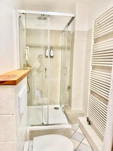 a bathroom with a shower and a toilet at House at Jenischpark in Hamburg