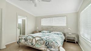 a bedroom with a bed and a window at On The Beach in Wooli