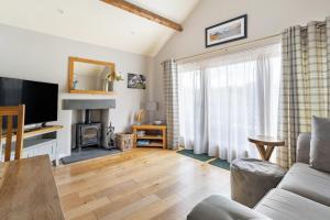 a living room with a couch and a television at 1 Bed in Hawkshead oc-lr154 in Hawkshead