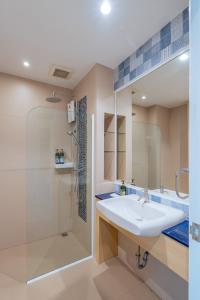 a bathroom with a sink and a shower at Aster Canopy Suites & Living in Rayong +163 photos