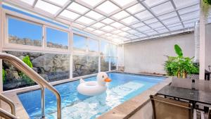 a swimming pool with a rubber duck in the middle at Seogwipo Dawa Pool Villa Pension in Seogwipo