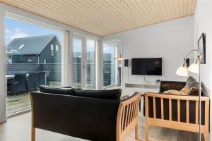 a living room with a couch and a television at 0341-Romo-Vestergade-351 in Høm