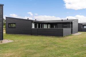 a black house with a grassy yard in front of it at 0341-Romo-Vestergade-351 in Høm