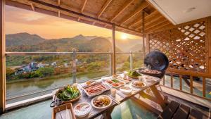 a cat sitting at a table with food on it at gapyeong newcastle pension in Gapyeong